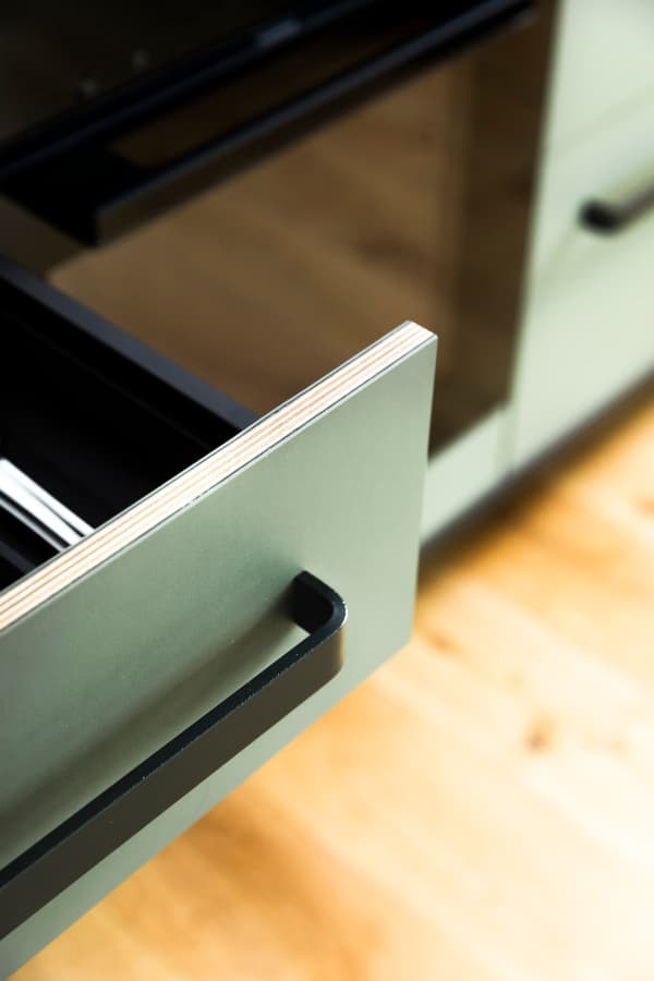 Detail view drawer with plywood visible edge and green linoleum